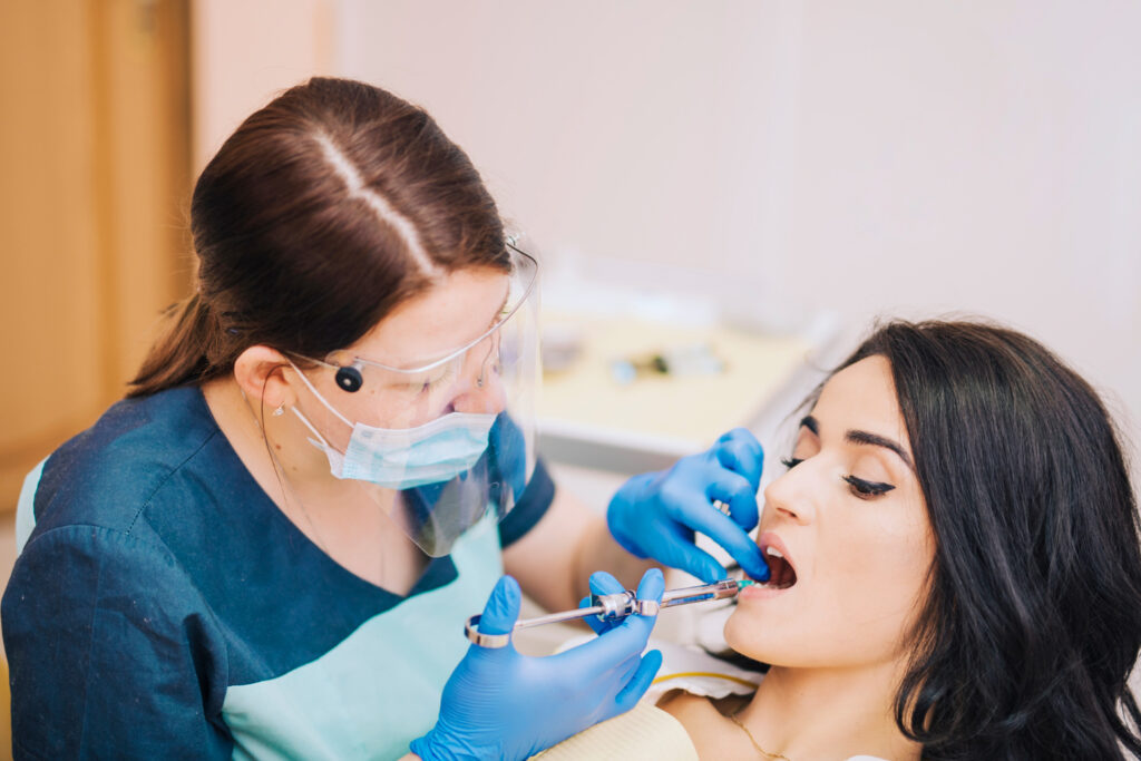 Cosmetic dentist fixing chipped teeth